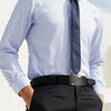 A man wearing a light blue dress shirt, dark tie, and black trousers with a black buckle belt.