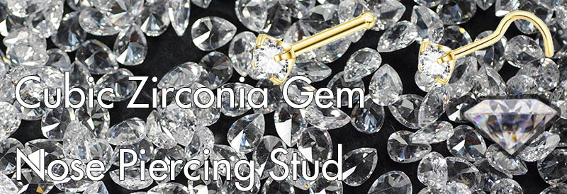 A close-up of cubic zirconia gems used as nose piercing studs, featuring a crystal and gold finish.