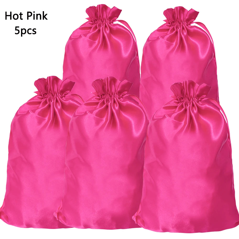 Five bright pink satin drawstring storage bags for hair tools