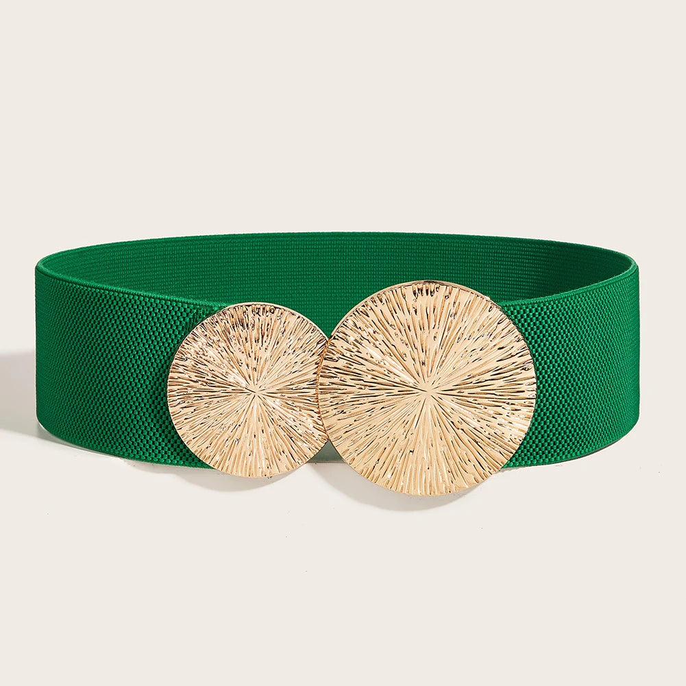 A dark green elastic waist belt with a gold-toned, textured circular buckle.