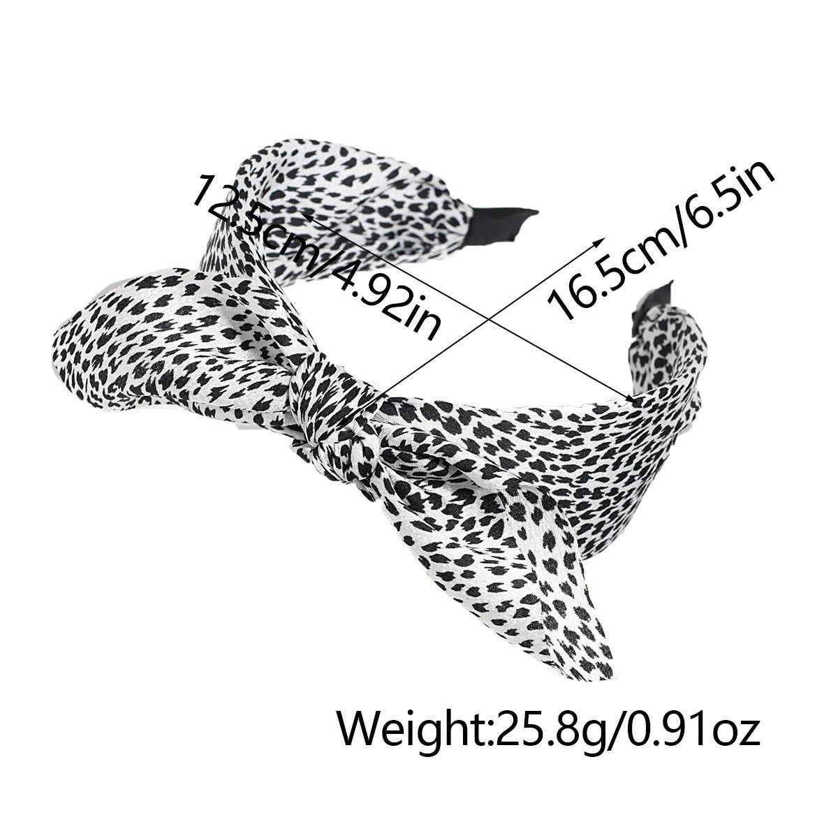 A black and white leopard print retro bow hairband shown against a white background.