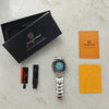 A black box containing a men's luxury quartz wristwatch with luminous features, along with an orange instruction card and a y