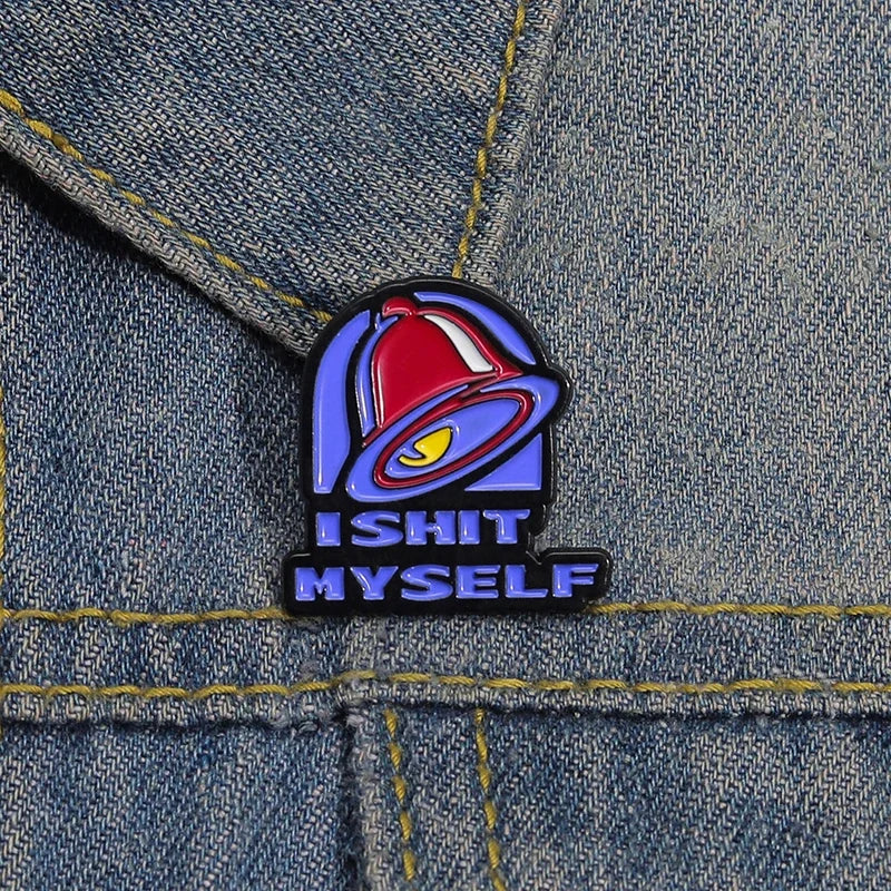 A vintage enamel pin featuring a red bell design with the text ISHIT MYSELF on a dark background.