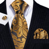 A black silk jacquard tie and matching patterned silk pocket square worn with a dark suit jacket.