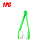 A single green plastic tool used for cleaning eyeglasses or similar items.