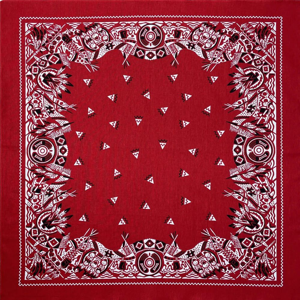 A red fabric with white embroidered patterns forming a decorative border around a central area.
