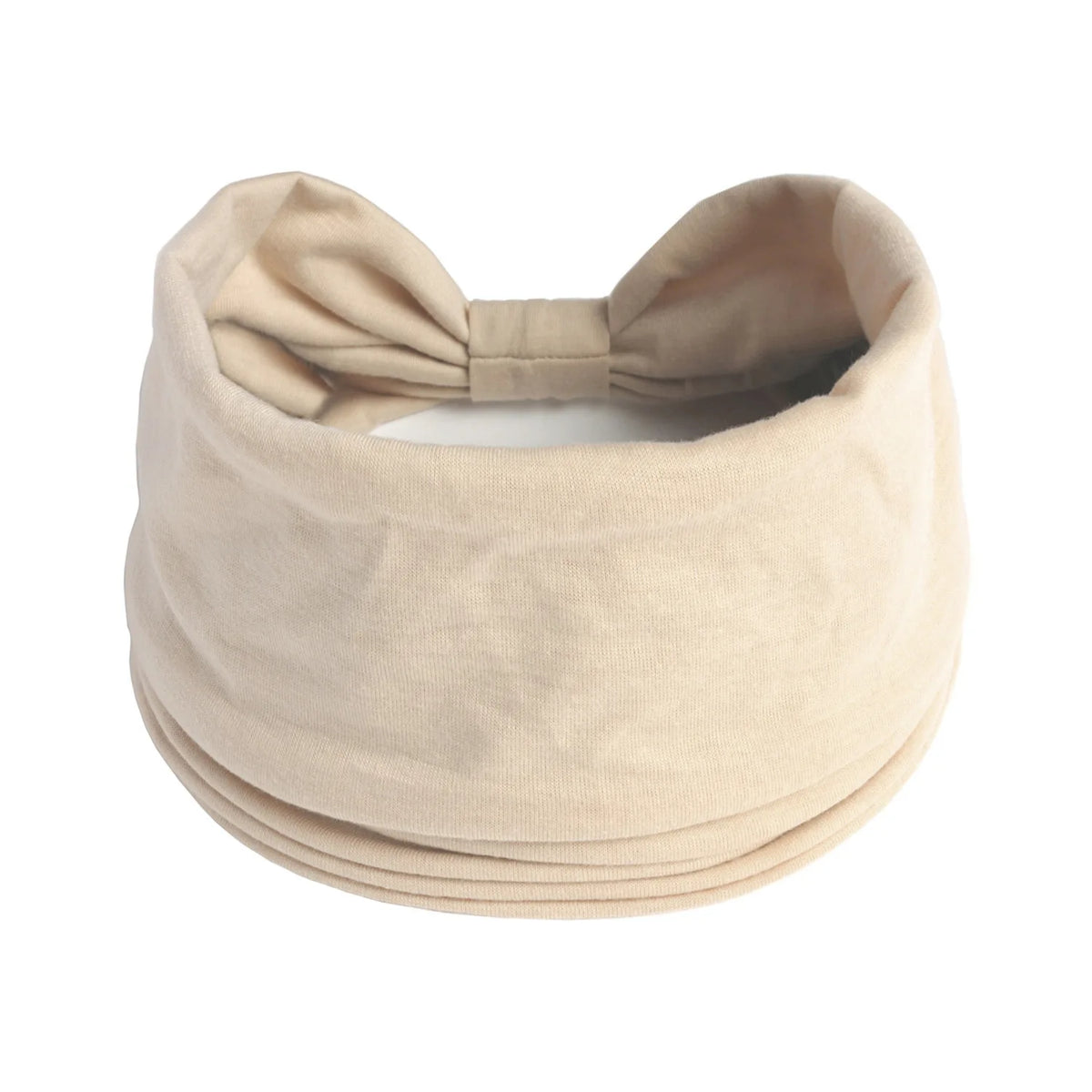 A beige boho knot headwrap hair band for women, folded and tied in a bow.