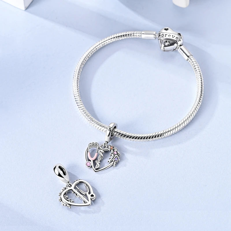 Sterling silver devil's eye charm bracelet with a heart pendant on a light blue background