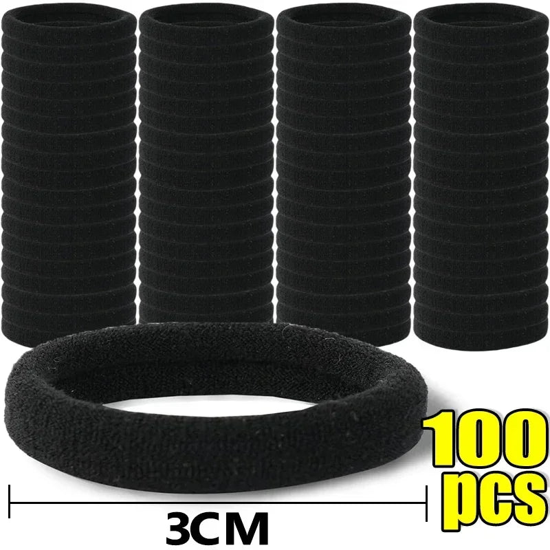 A set of black elastic hair bands stacked in columns with a single band displayed below, measuring 3cm wide.
