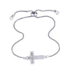 An adjustable gold-plated cross bracelet adorned with cubic zirconia stones.