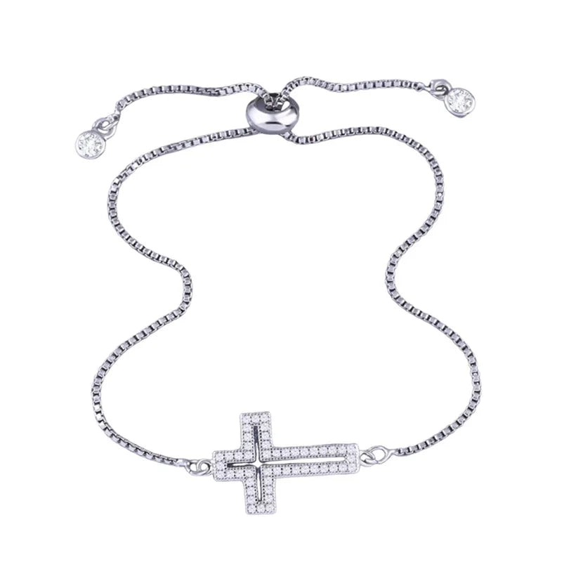 An adjustable gold-plated cross bracelet adorned with cubic zirconia stones.