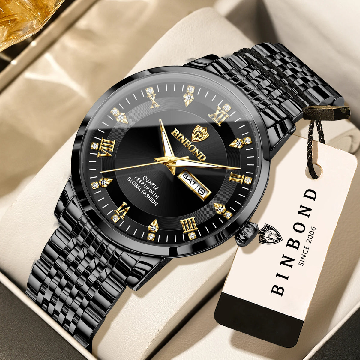 A black and gold Binbond quartz wristwatch with a textured strap is displayed on a light background.