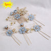 A set of five floral pearl bridal hair accessories featuring light blue flowers and gold accents.