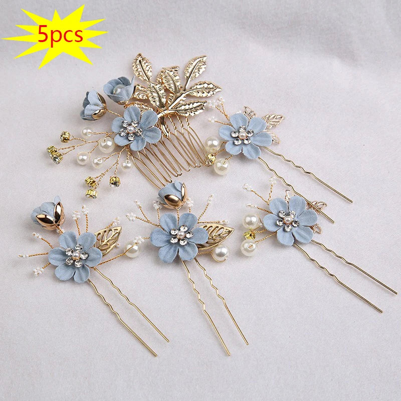 A set of five floral pearl bridal hair accessories featuring light blue flowers and gold accents.