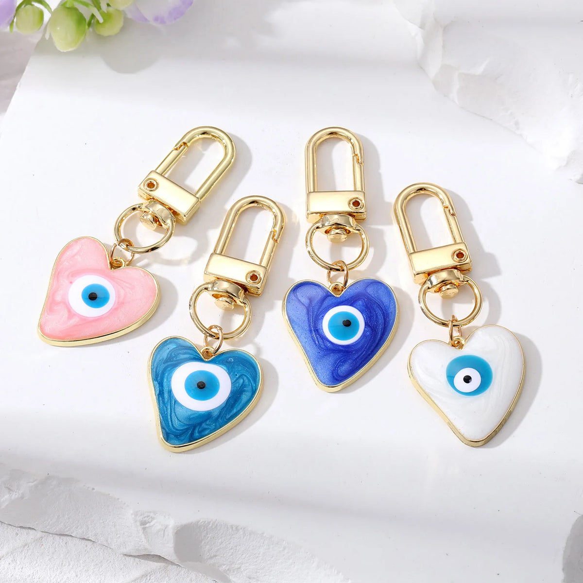 Gold heart-shaped keychain with blue and white evil eye design