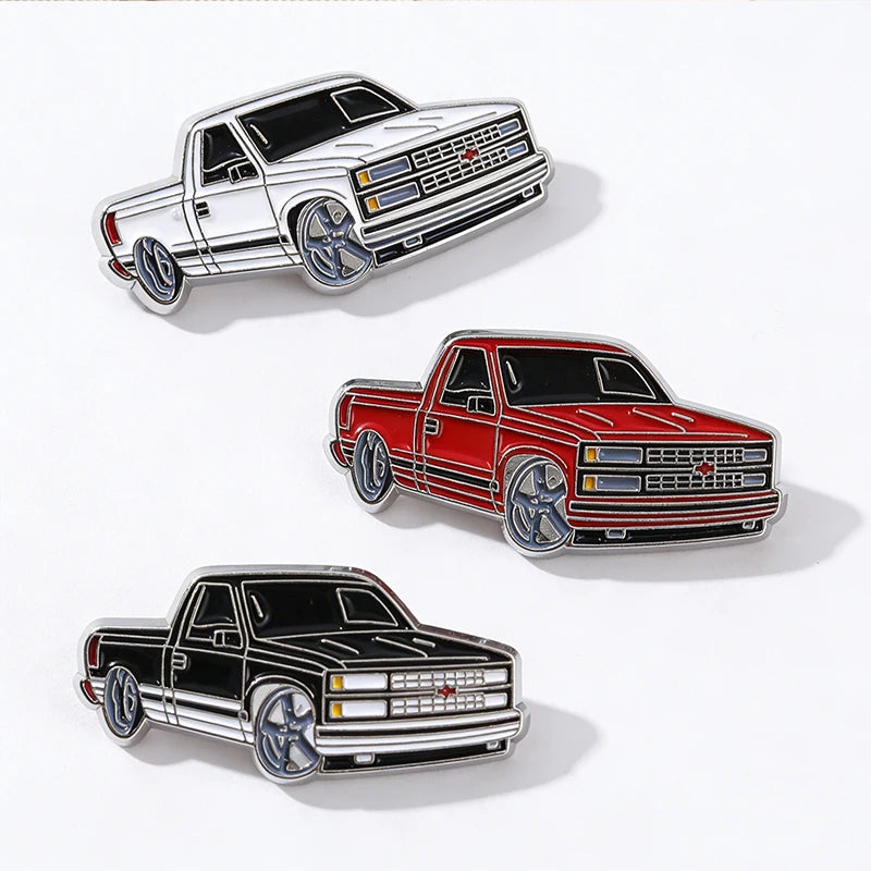 A collection of three metal clip pins depicting various truck models in retro Mexico style.