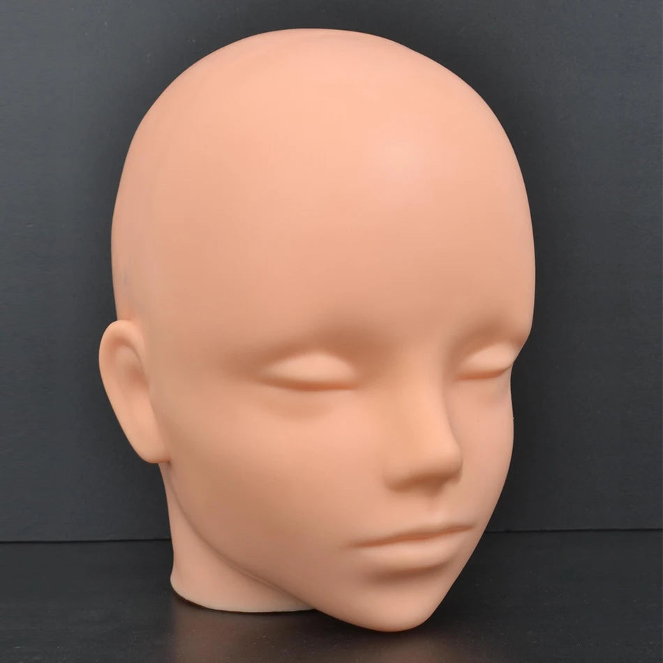 A smooth, peach-colored professional mannequin head used for wig practice and display.