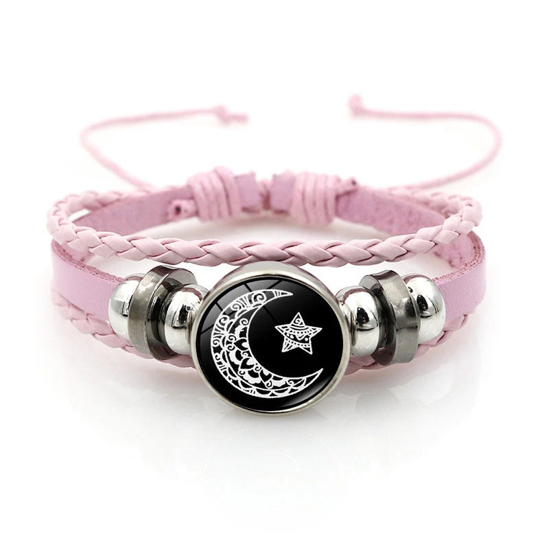 Pink braided bracelets featuring silver and black charms with crescent moon and star designs