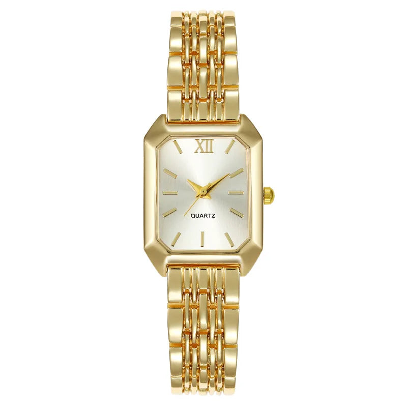A gold minimalist quartz watch with a silver dial and a gold link bracelet.