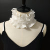 A black sweater displayed on a mannequin featuring a white decorative pleated ruffle stand collar.