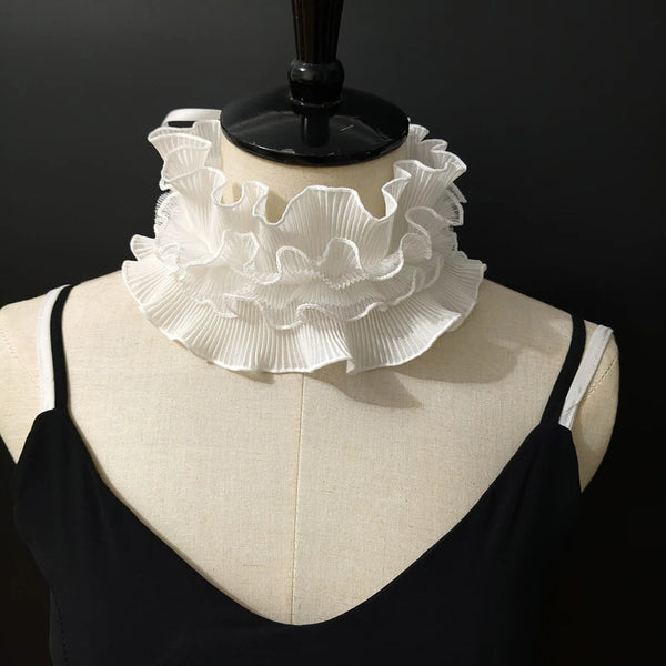 A black sweater displayed on a mannequin featuring a white decorative pleated ruffle stand collar.