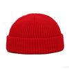 A bright red knitted beanie cap with a ribbed cuff.