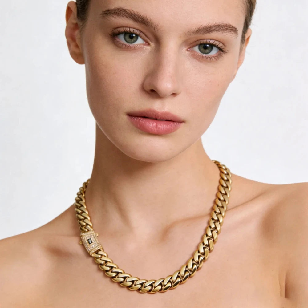 A close-up of a woman wearing a gold-plated Miami Cuban chain necklace on her neck.