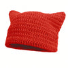A bright red crocheted beanie hat with cat ear design.