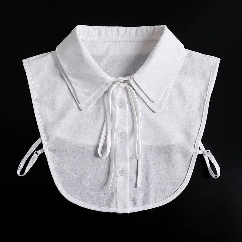 White blouse with a false collar and detachable neckline, shown flat lay.