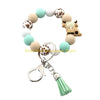 A silicone wristlet keychain featuring a decorative Highland cow design with various pastel colored cow heads.