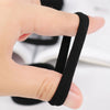 A hand is holding a black seamless hair tie, demonstrating its use for ponytail holders.