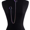 A chunky heart slip chain necklace with iridescent purple and green accents displayed on a black mannequin.
