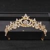 Gold crystal rhinestone bridal tiara headpiece displayed on a black box.