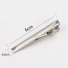 Silver metal tie clip shown with dimensions of 6cm in length and 0.6cm width.