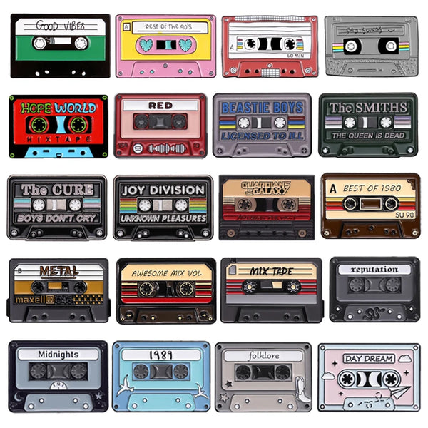A collection of 12 enamel pin brooches featuring various retro cassette tape designs and band names
