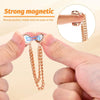 Hands demonstrate the strong magnetic clothing clips, showing their suction and stability.