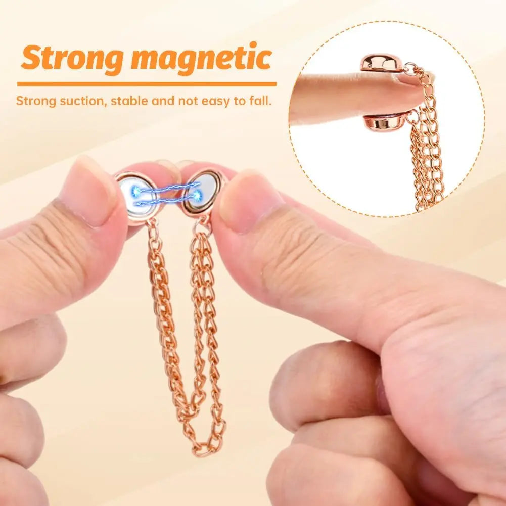 Hands demonstrate the strong magnetic clothing clips, showing their suction and stability.