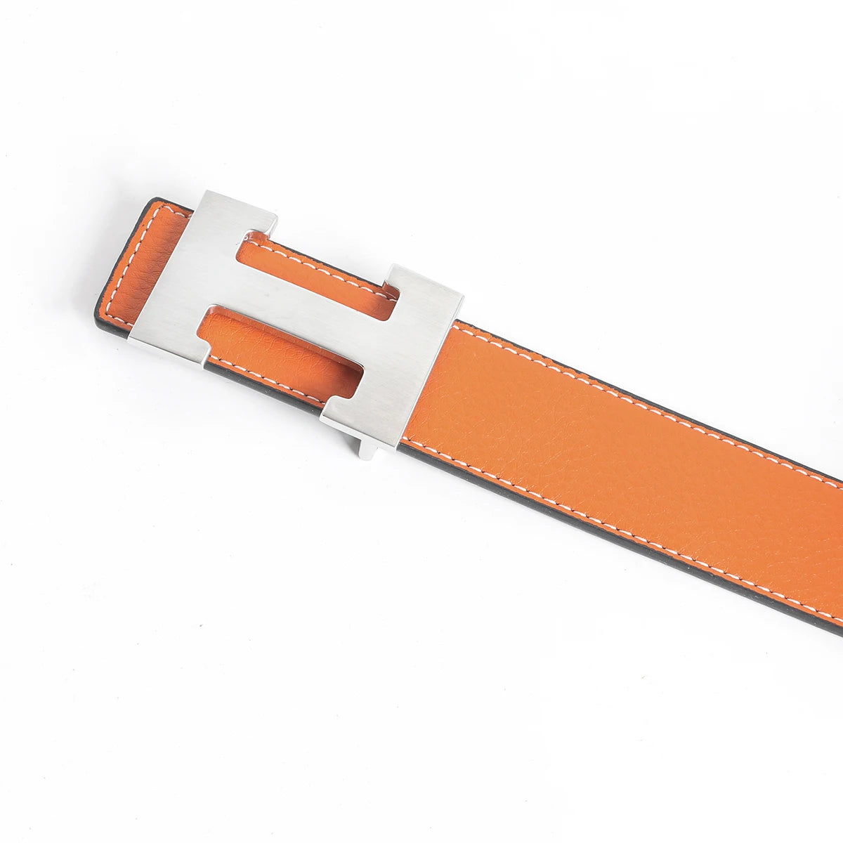 A genuine leather dress belt with a silver buckle and orange leather strap.