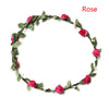 A delicate rose floral wreath headband made of green leaves and pink roses.