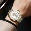 A close-up of a gold-toned luxury quartz wristwatch for men with a silver case and luminous display on a wrist.
