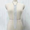 A long, silver crystal rhinestone sequin necklace displayed on a mannequin's neck.