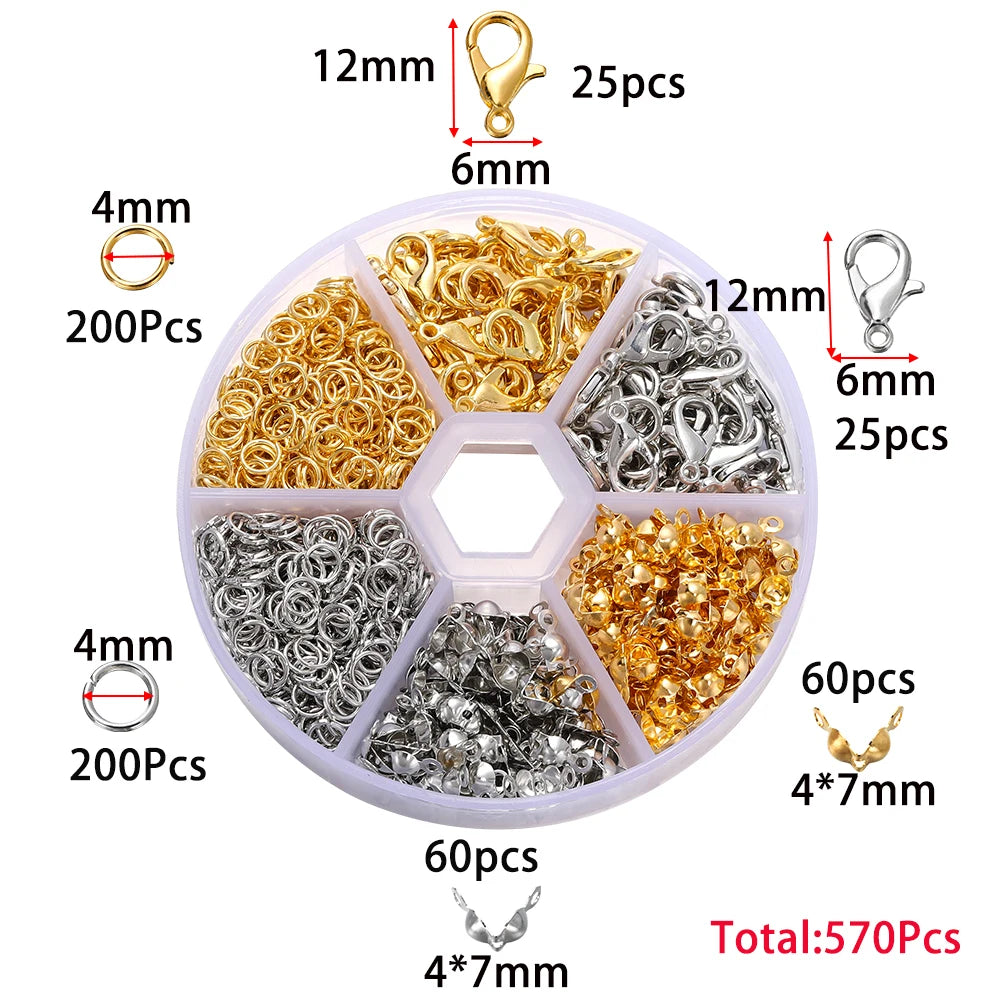 A plastic container holding various gold and silver jewelry findings including clasps, hooks, and jump rings.
