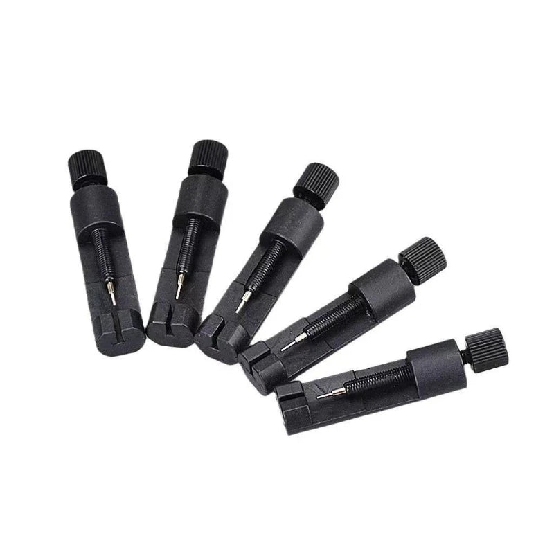 A set of black adjustable watch band link repair kits with metal pins and tools.