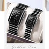 A pair of black luxury quartz watches with silver accents displayed on a light-colored surface.