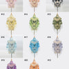 A collection of twenty-one elegant printed butterfly lace scarves and shawls displayed on hangers.