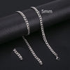 Silver stainless steel Cuban link necklace displayed on a black background with a 5mm scale marker.