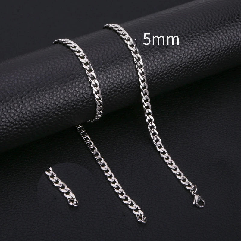 Silver stainless steel Cuban link necklace displayed on a black background with a 5mm scale marker.