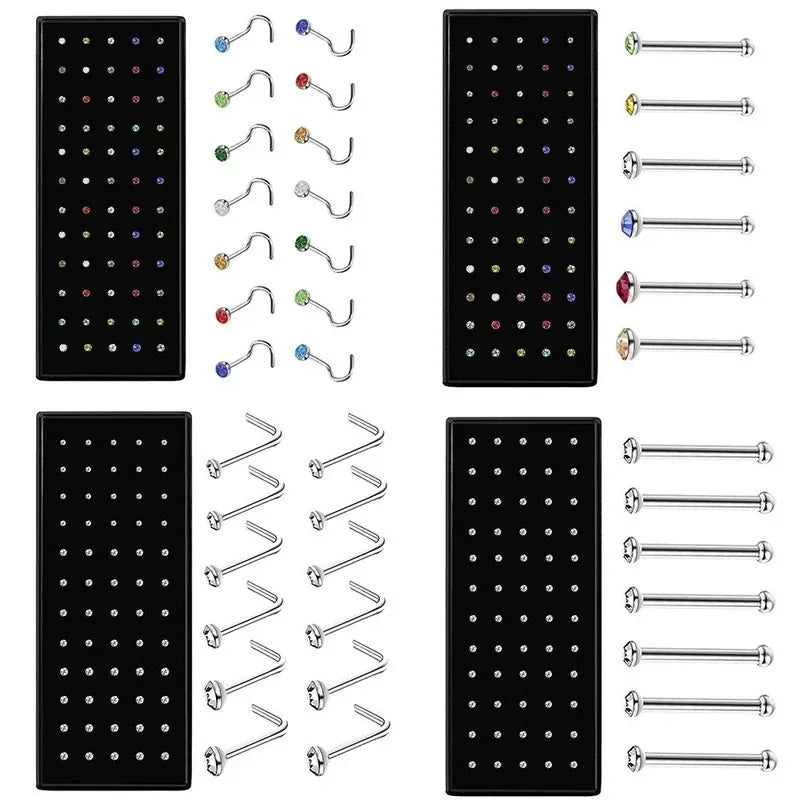 A collection of stainless steel nose studs and body piercing jewelry in various sizes and styles.