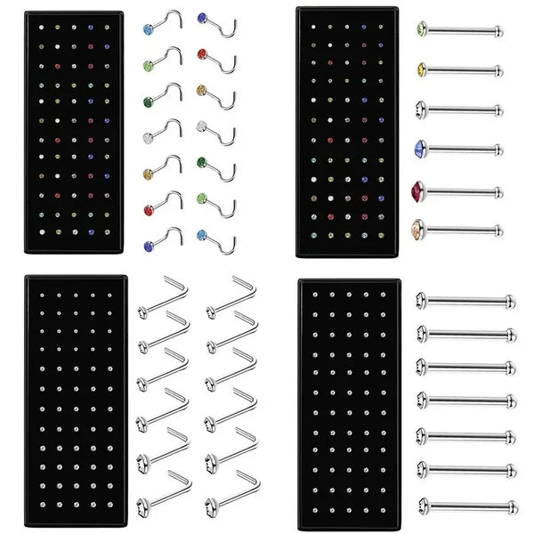 A collection of stainless steel nose studs and body piercing jewelry in various sizes and styles.
