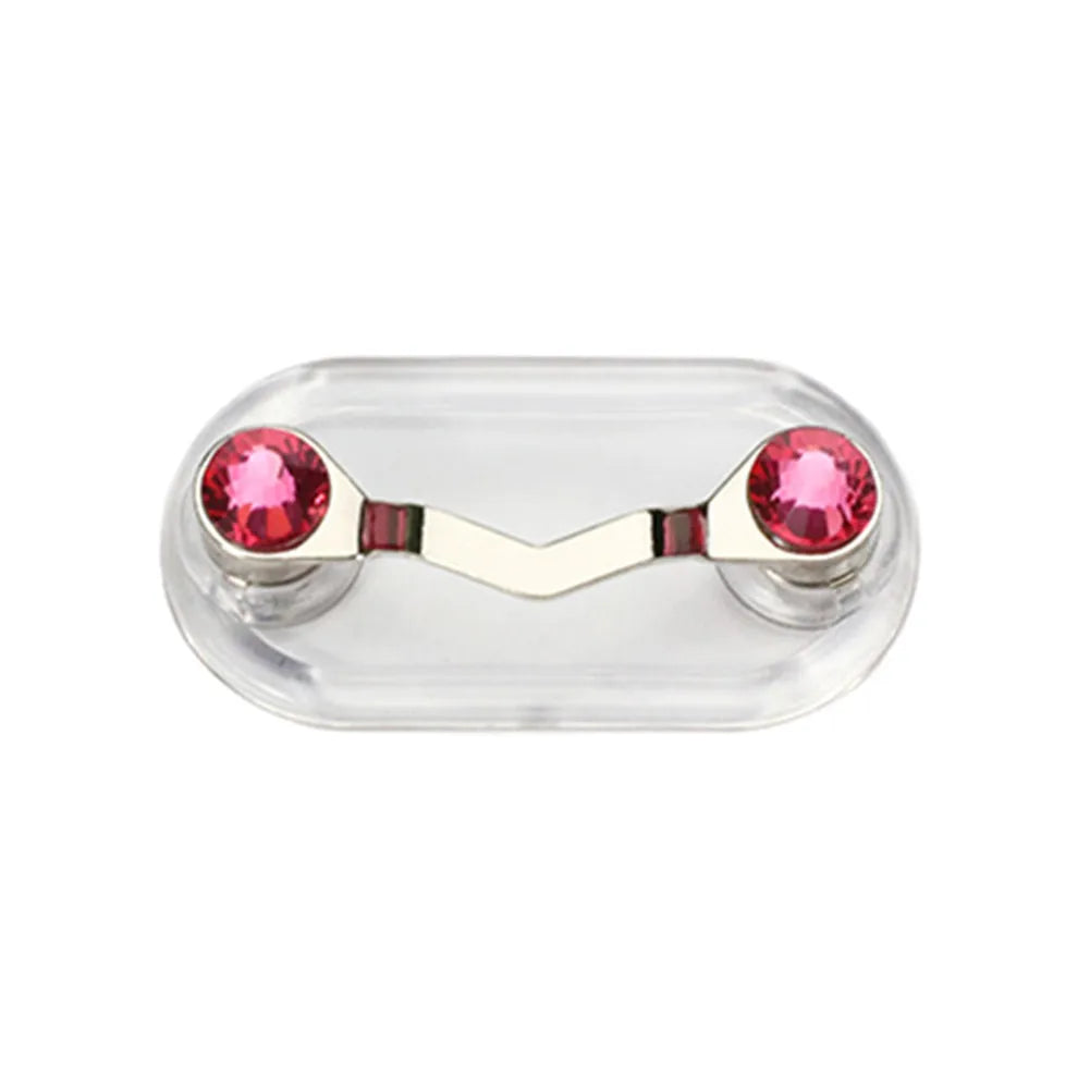 A clear plastic magnetic clip with two pink gemstones used to hold eyeglasses.